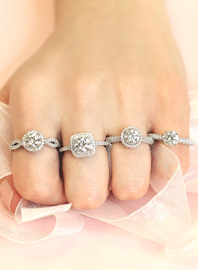 real diamond rings, 4 diamond rings in different cuts on woman's fingers