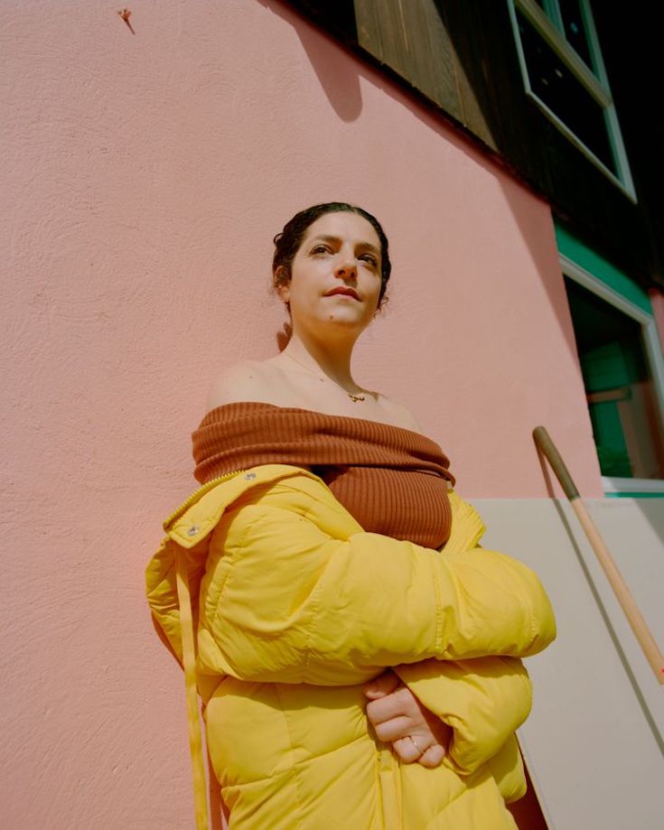 Celine Semaan Vernon in orange dress and yellow coat