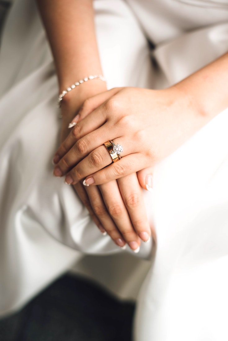 Bride wearing matching gold wedding bands