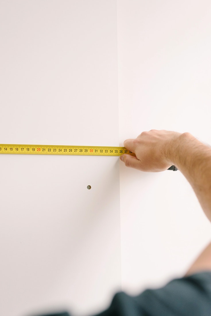 Person measuring walls