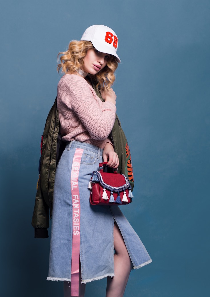 Fashion faux pas, woman in jacket, skirt, ball cap, sweater