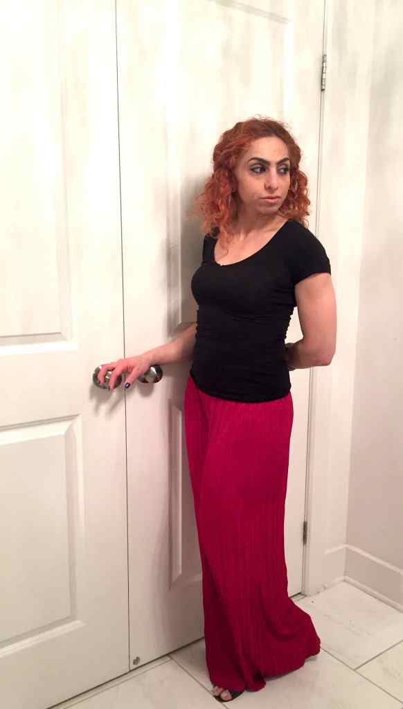 Rania in gaucho pleated red pants with black top and perforated shoes