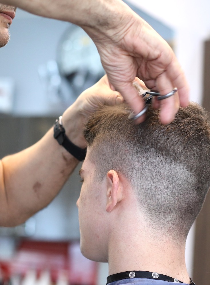 Men's styling, barber cutting hair
