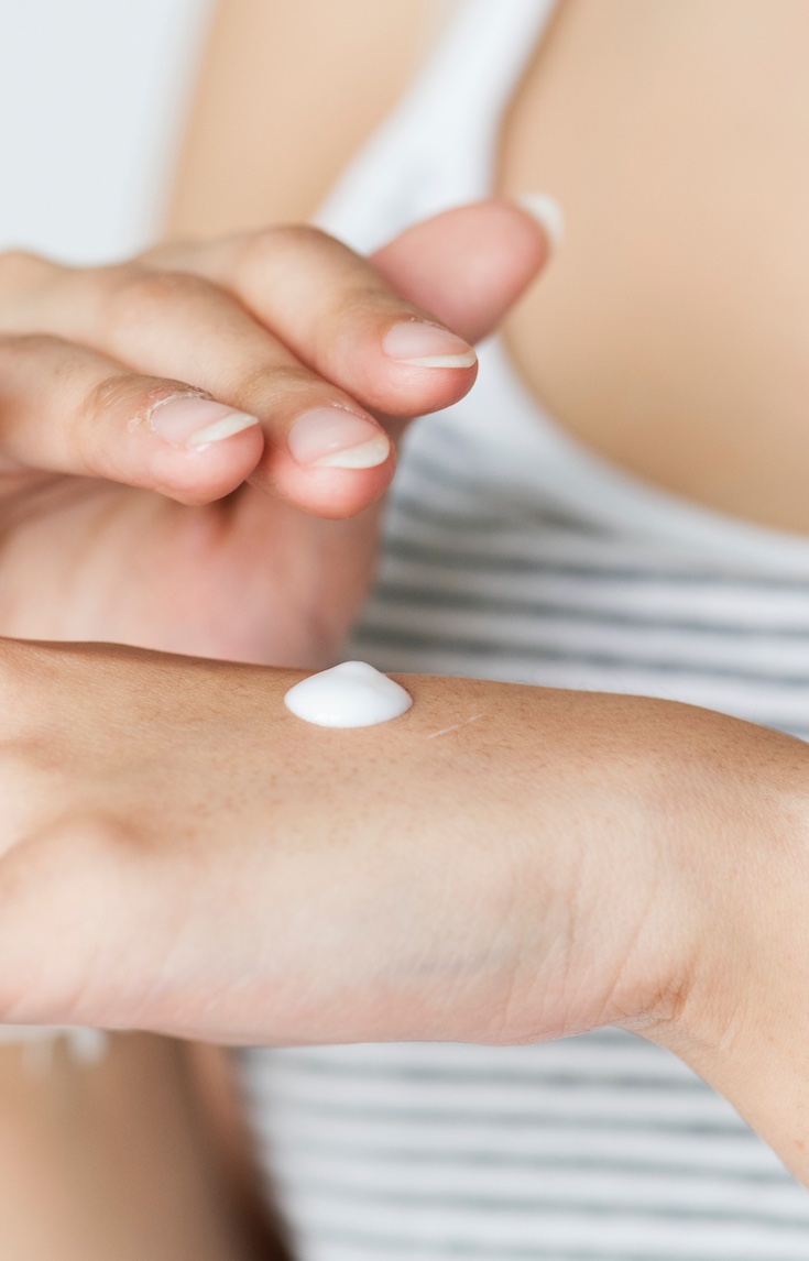 Skincare routine, lotion on hands