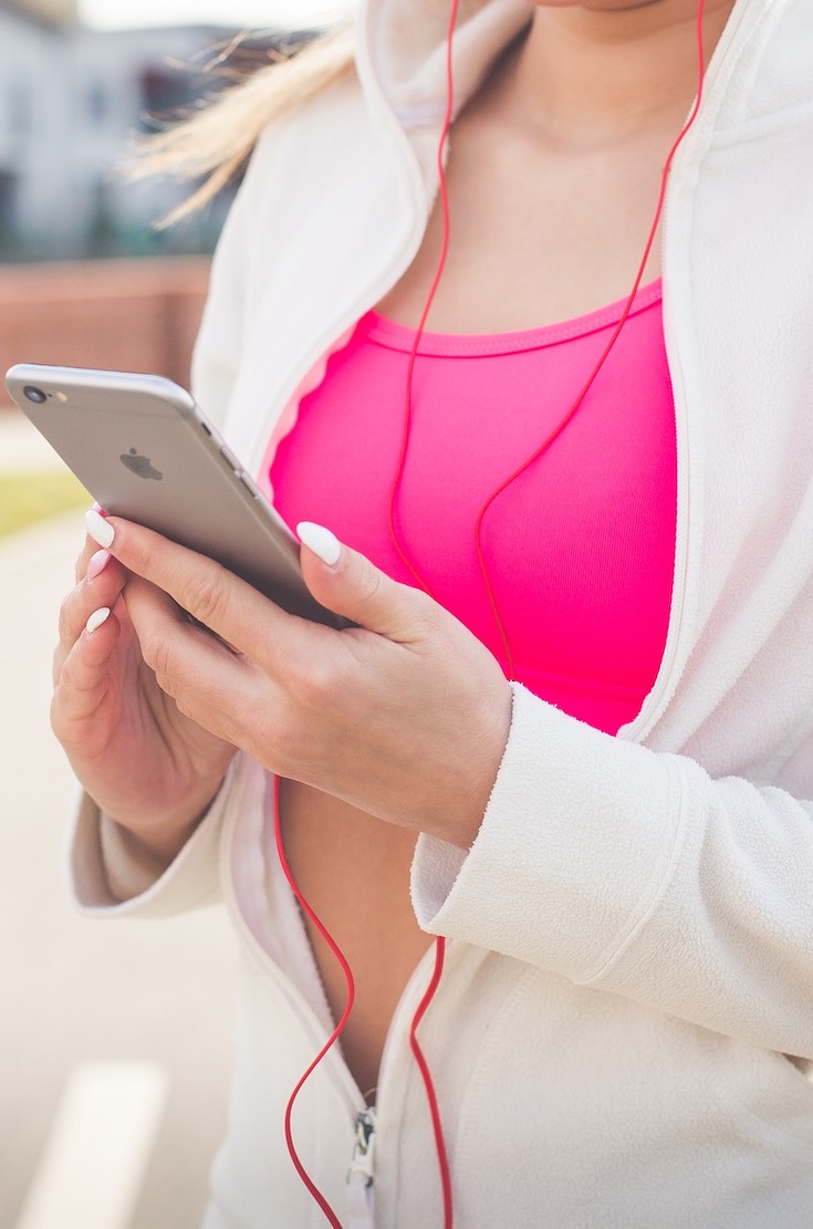 Woman checking phone while exercising