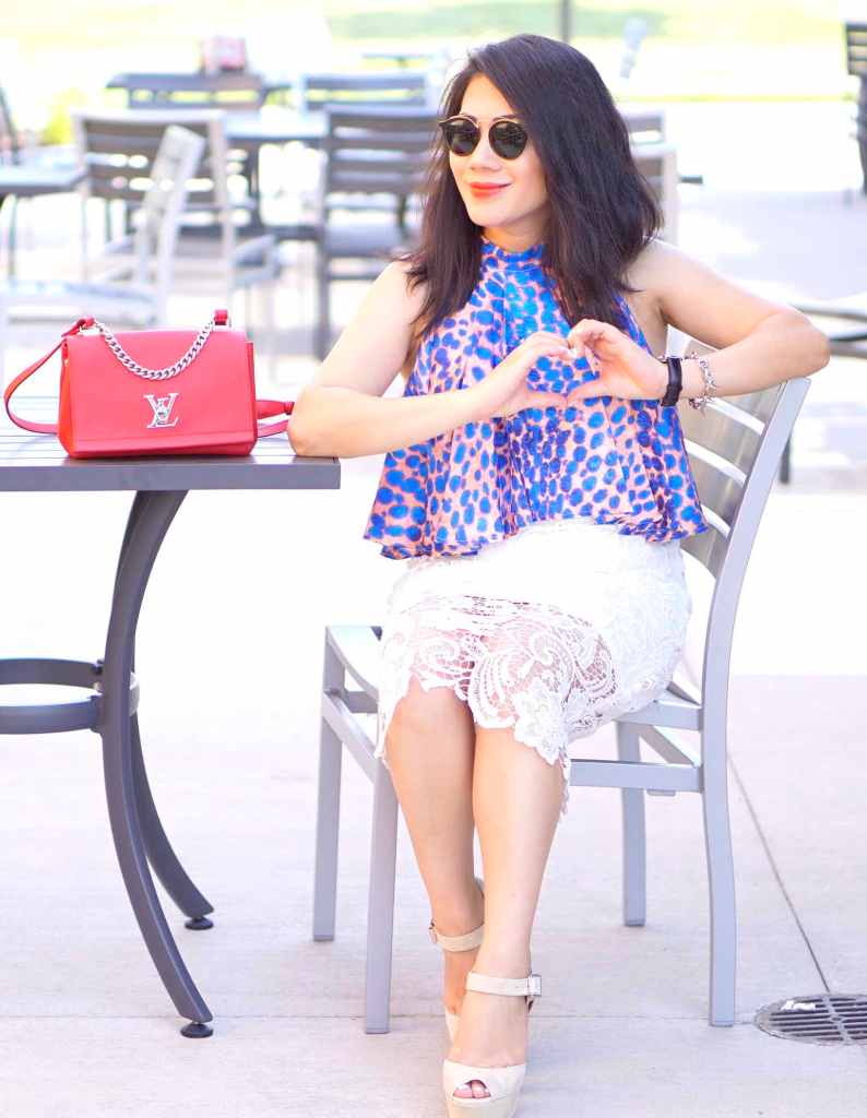 Grace in lace white skirt and printed blue top with red purse