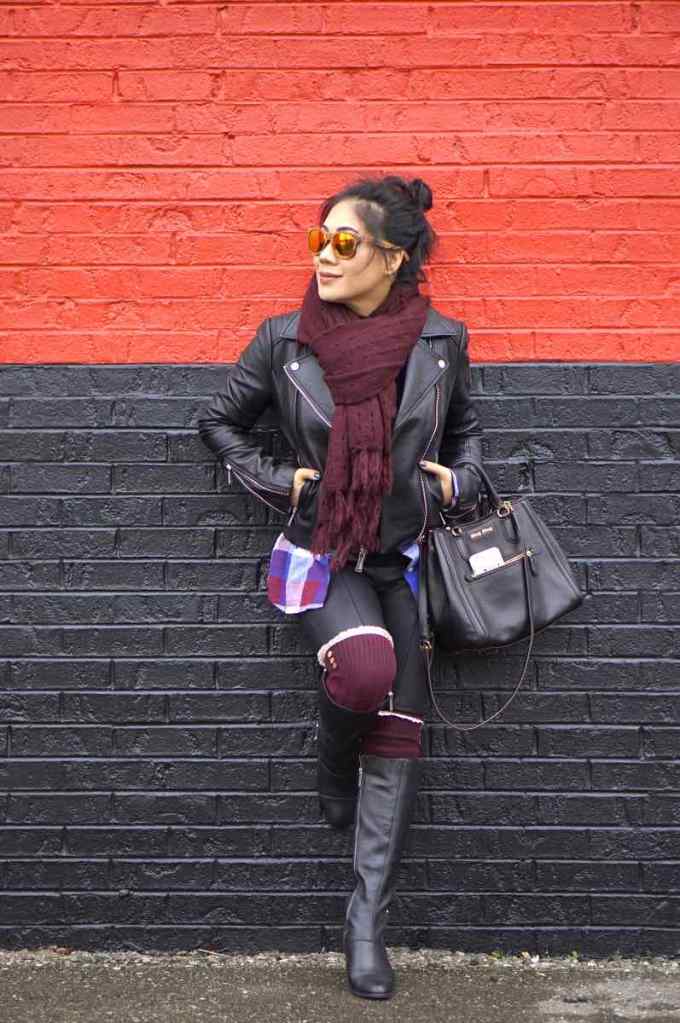 Motorcycle leather jacket with burgundy scarf, leggings, and black boots