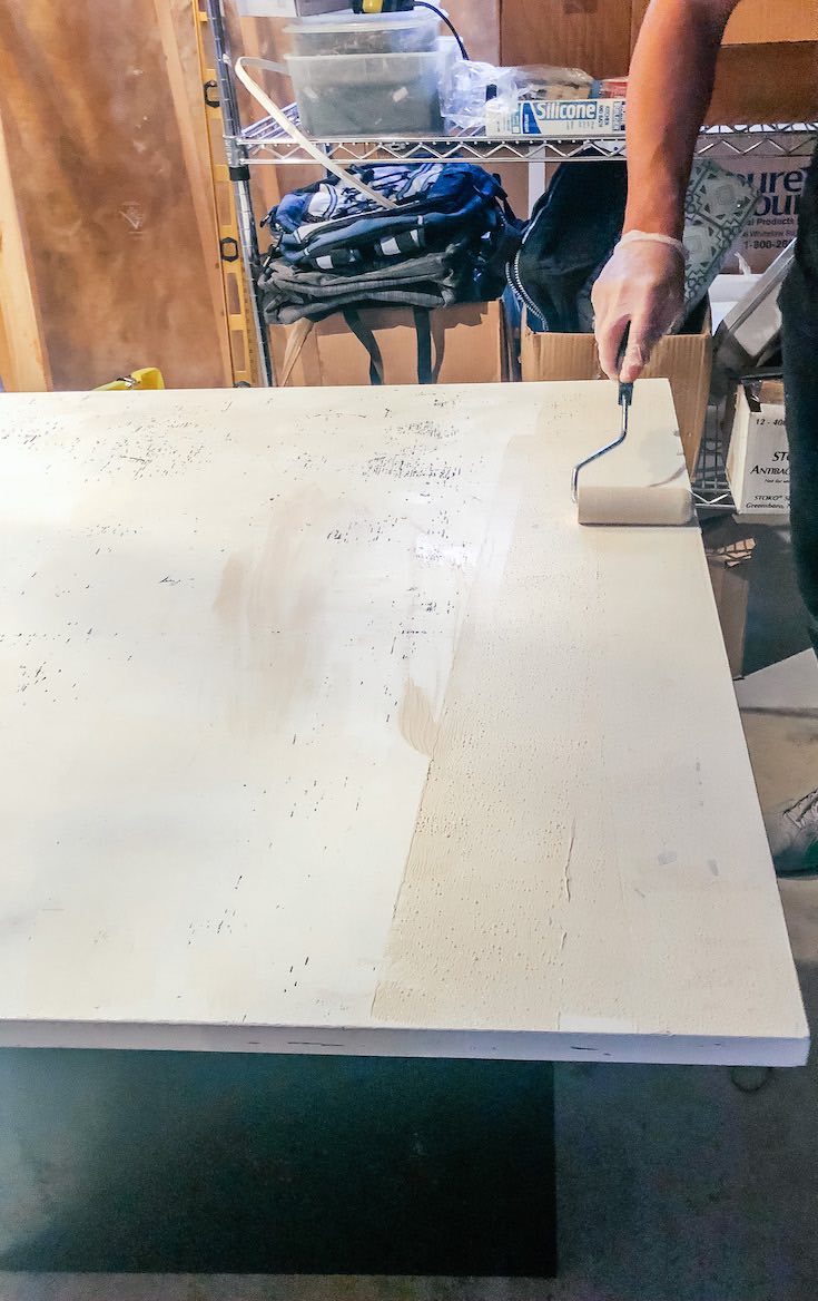 Applying base coat on table surface