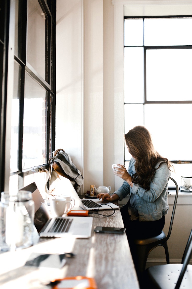 Woman working at desk in denim jacket
