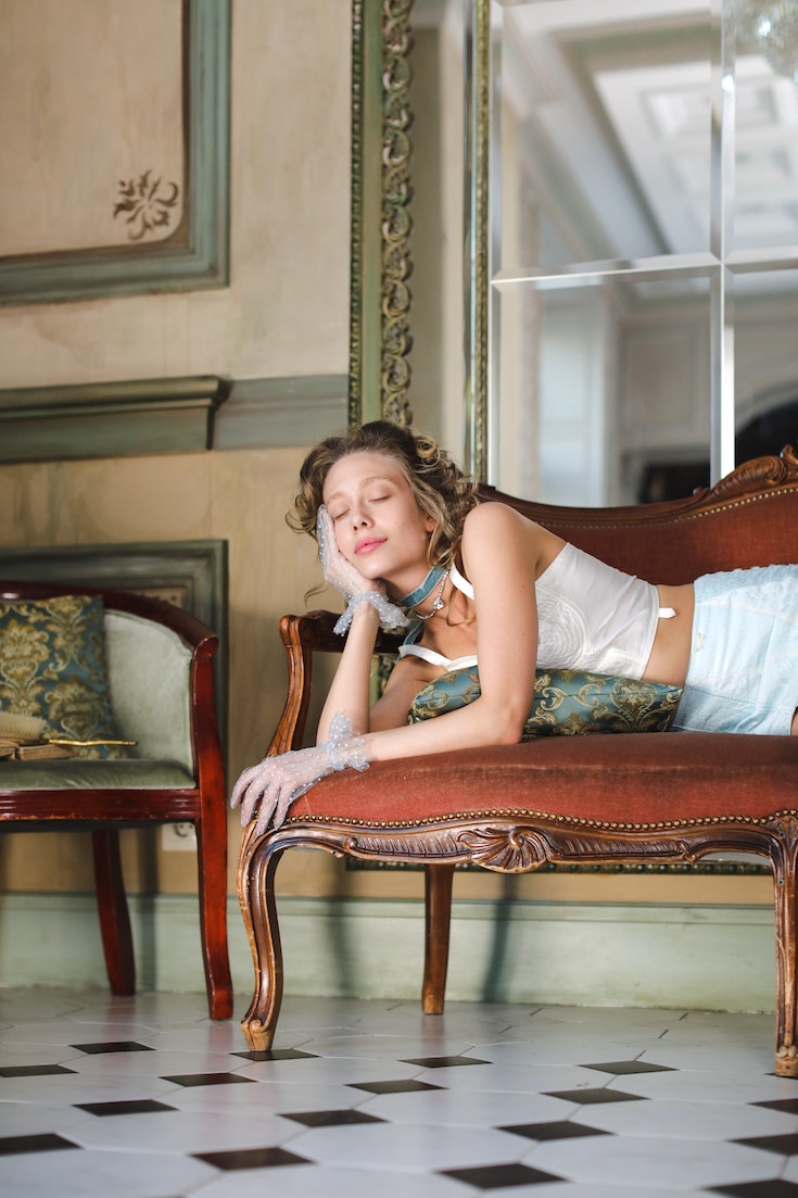 Woman in lingerie lying on couch