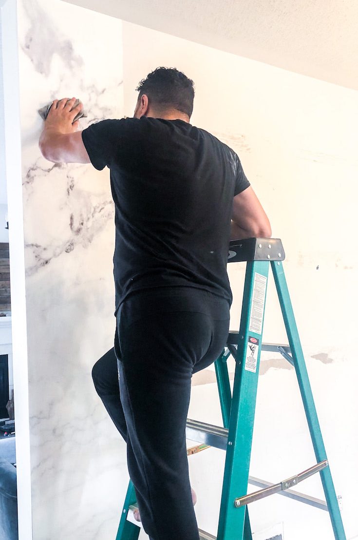 Pasting wallpaper on wall