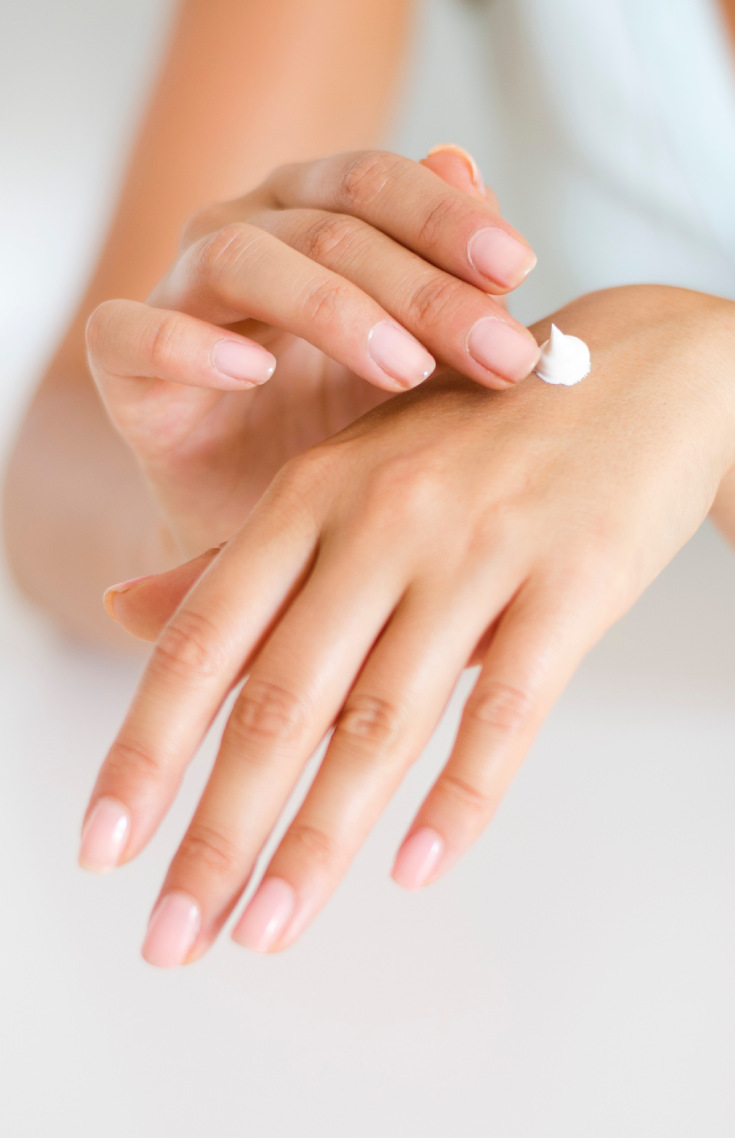 Woman applying lotion, skincare routine