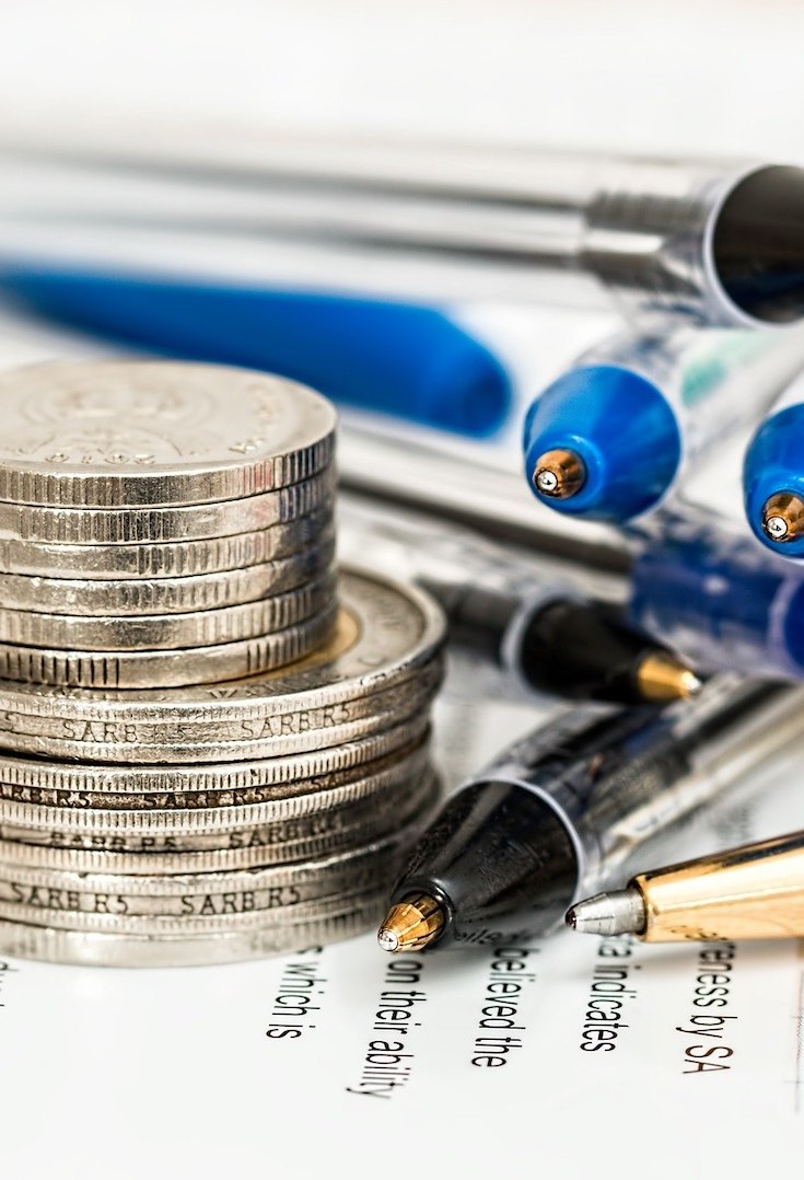 Coins, pens and papers, budgeting