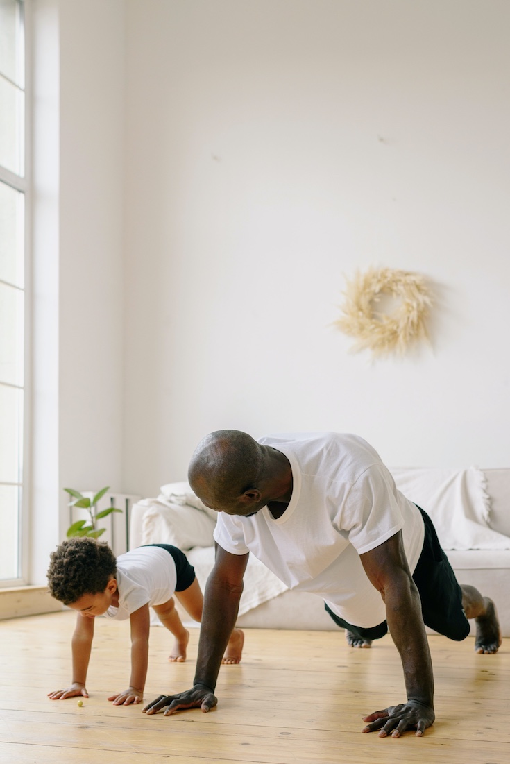 Boy and dad exercising at home